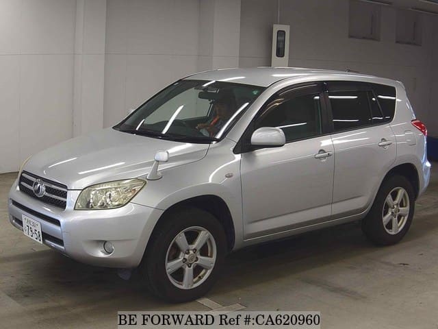 A grey JDM sports car speeding down a highway at night.