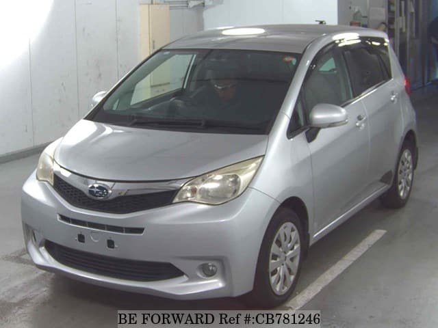 A grey JDM sports car speeding down a highway at night.