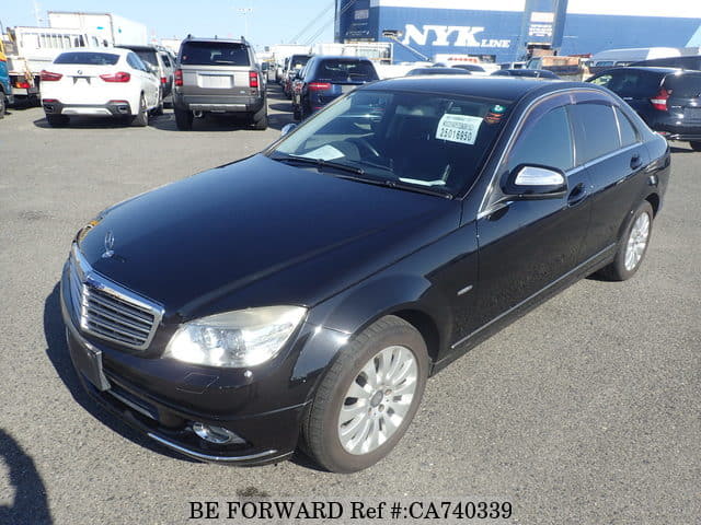 A grey JDM sports car speeding down a highway at night.