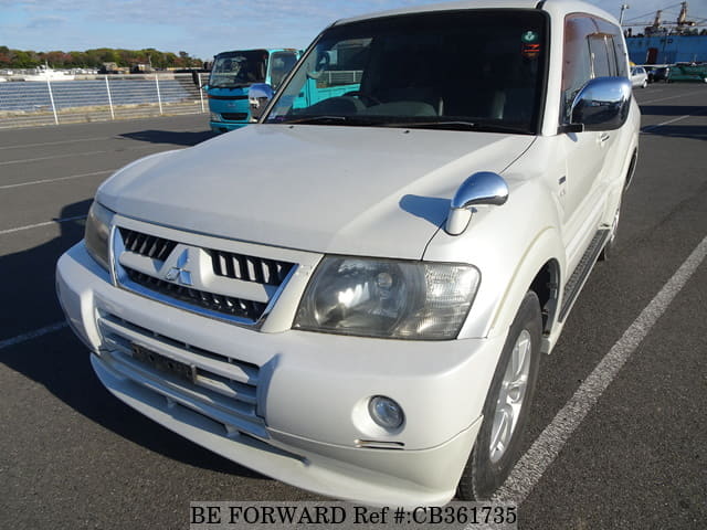 A grey JDM sports car speeding down a highway at night.