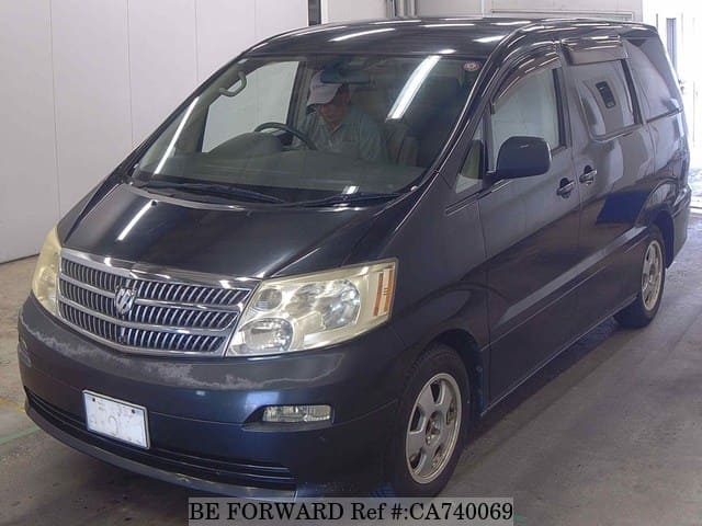 A grey JDM sports car speeding down a highway at night.