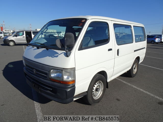 A grey JDM sports car speeding down a highway at night.