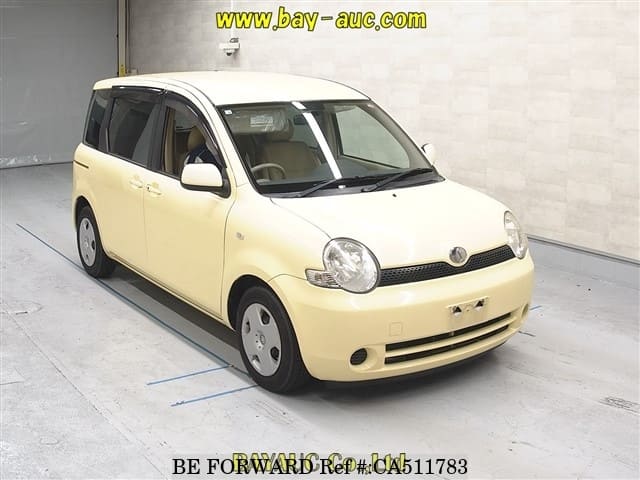 A grey JDM sports car speeding down a highway at night.