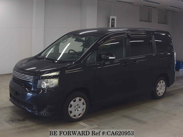 A grey JDM sports car speeding down a highway at night.