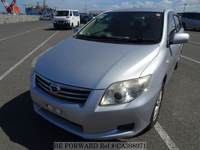 A grey JDM sports car speeding down a highway at night.
