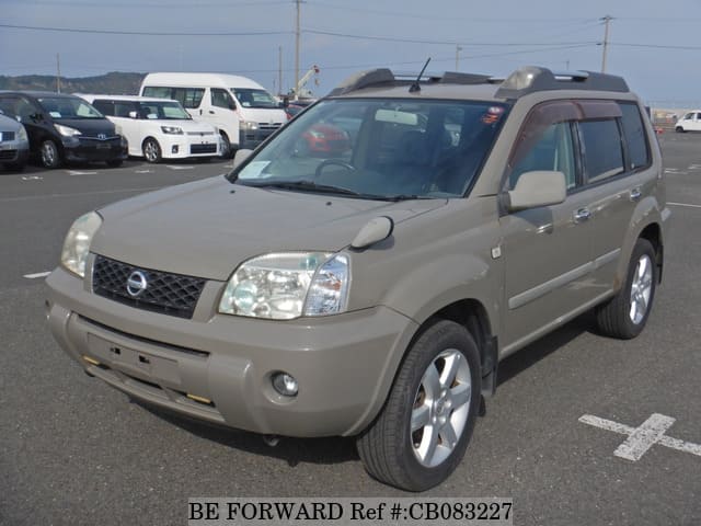 A grey JDM sports car speeding down a highway at night.