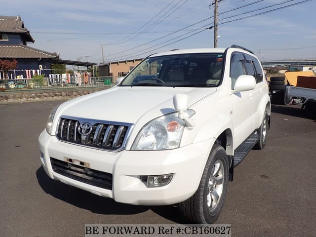 A grey JDM sports car speeding down a highway at night.