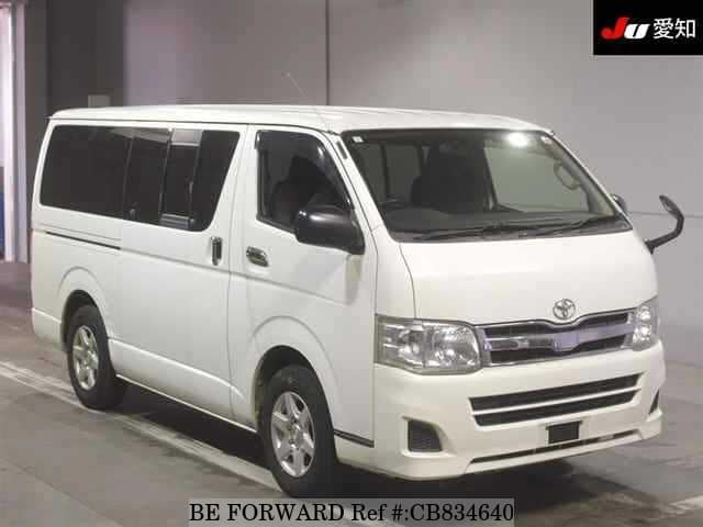 A grey JDM sports car speeding down a highway at night.