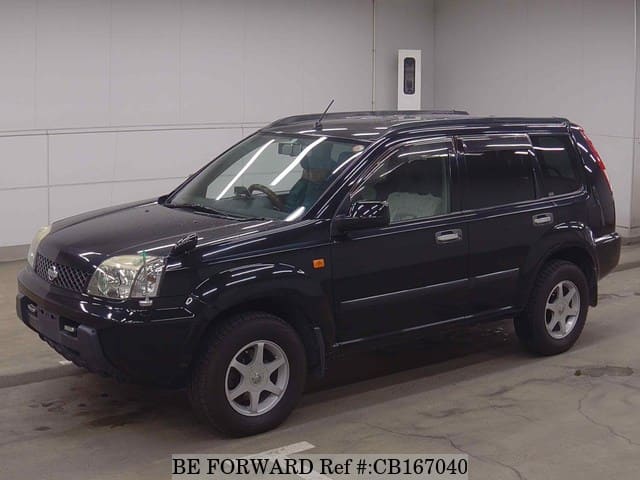 A grey JDM sports car speeding down a highway at night.
