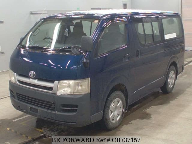 A grey JDM sports car speeding down a highway at night.