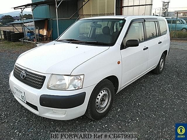 A grey JDM sports car speeding down a highway at night.