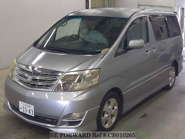 A grey JDM sports car speeding down a highway at night.