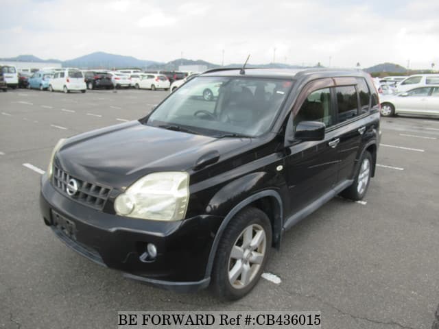 A grey JDM sports car speeding down a highway at night.
