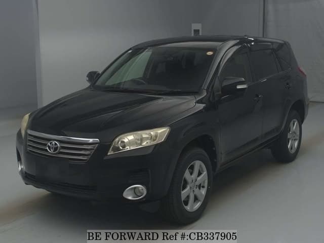 A grey JDM sports car speeding down a highway at night.