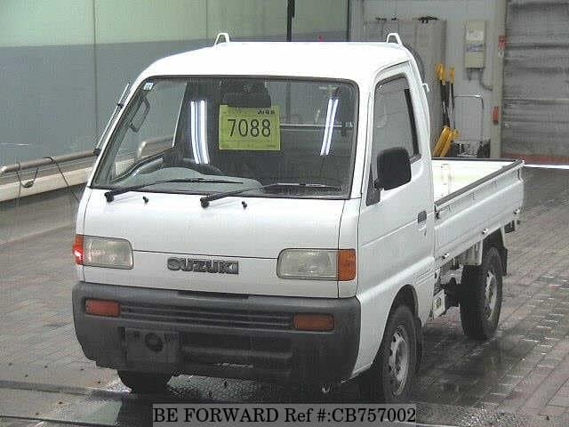 A grey JDM sports car speeding down a highway at night.