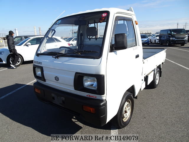A grey JDM sports car speeding down a highway at night.