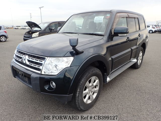 A grey JDM sports car speeding down a highway at night.