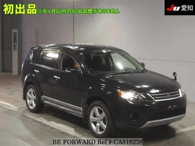 A grey JDM sports car speeding down a highway at night.