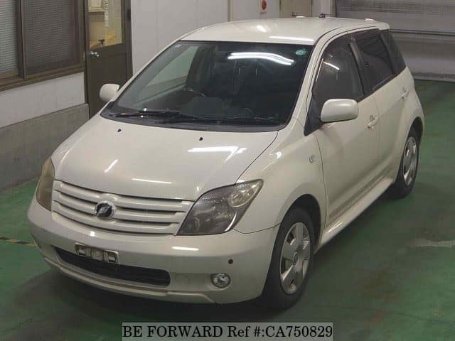 A grey JDM sports car speeding down a highway at night.