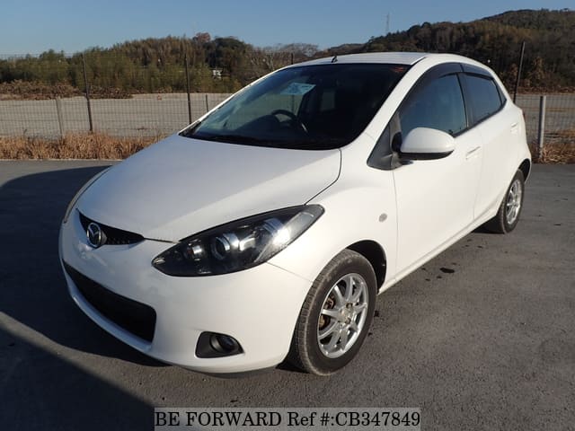 A grey JDM sports car speeding down a highway at night.