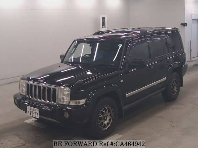 A grey JDM sports car speeding down a highway at night.