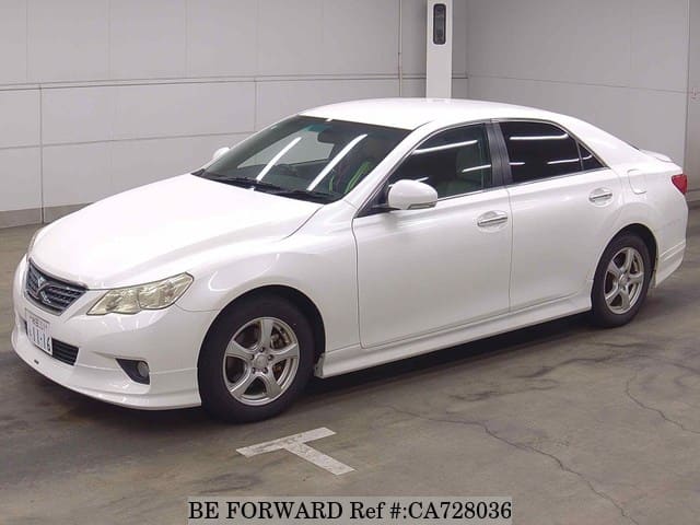 A grey JDM sports car speeding down a highway at night.
