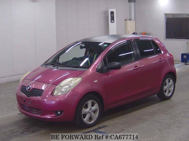 A grey JDM sports car speeding down a highway at night.