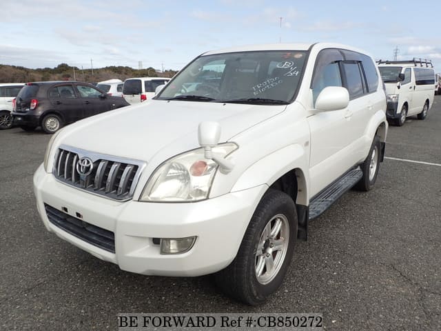 A grey JDM sports car speeding down a highway at night.