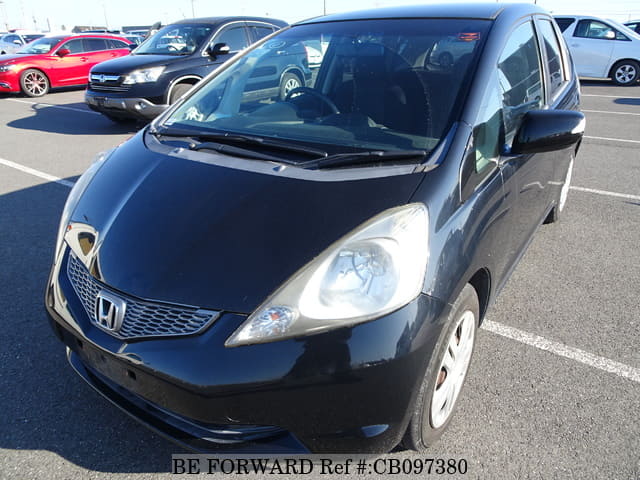 A grey JDM sports car speeding down a highway at night.
