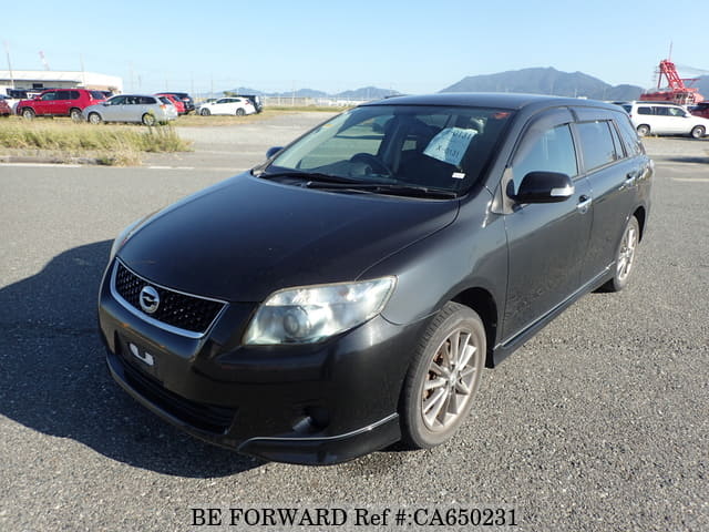 A grey JDM sports car speeding down a highway at night.