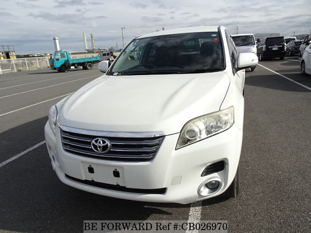 A grey JDM sports car speeding down a highway at night.
