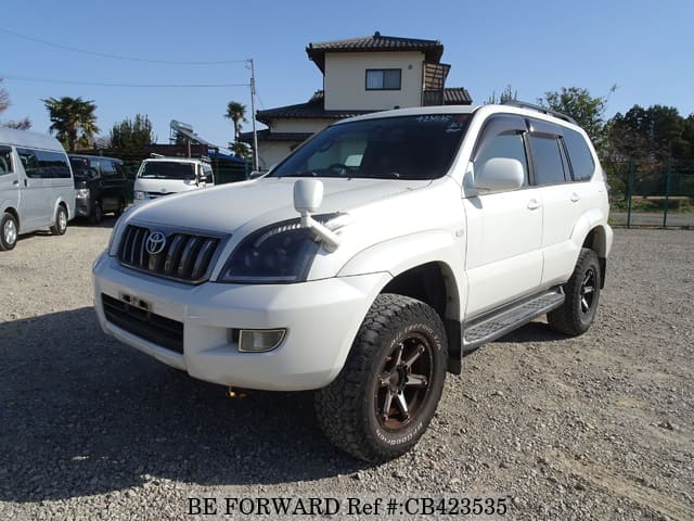 A grey JDM sports car speeding down a highway at night.