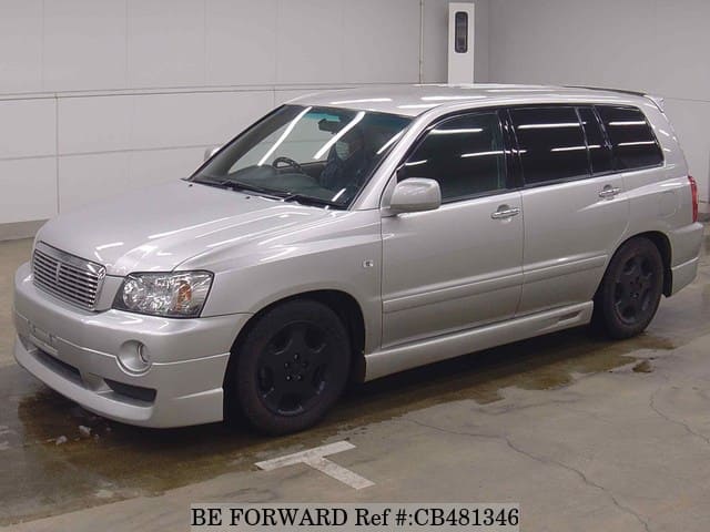 A grey JDM sports car speeding down a highway at night.