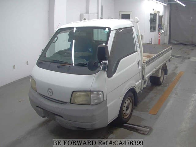 A grey JDM sports car speeding down a highway at night.