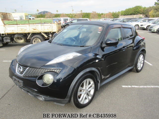 A grey JDM sports car speeding down a highway at night.