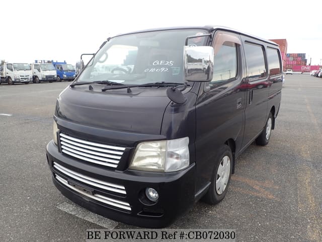 A grey JDM sports car speeding down a highway at night.