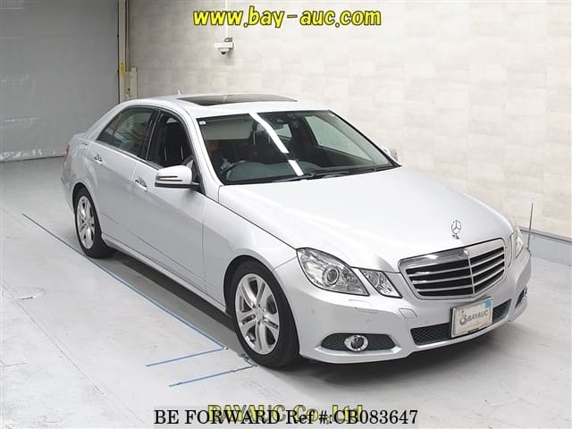 A grey JDM sports car speeding down a highway at night.