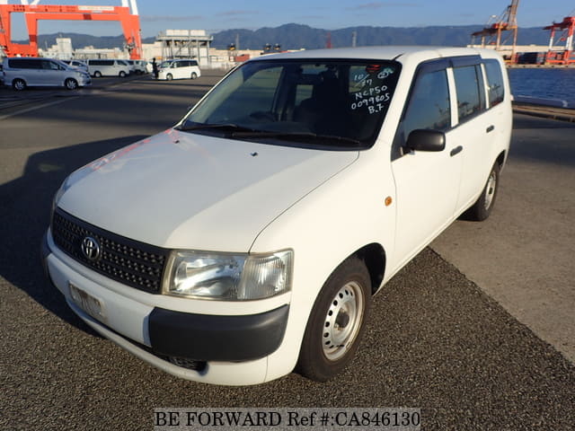 A grey JDM sports car speeding down a highway at night.