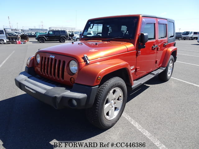 A grey JDM sports car speeding down a highway at night.