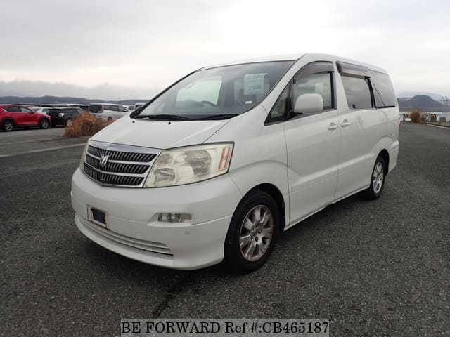A grey JDM sports car speeding down a highway at night.