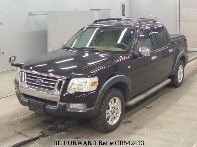 A grey JDM sports car speeding down a highway at night.