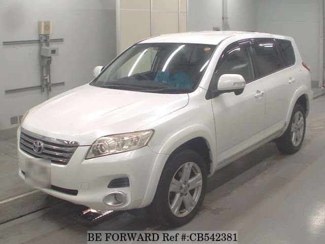 A grey JDM sports car speeding down a highway at night.