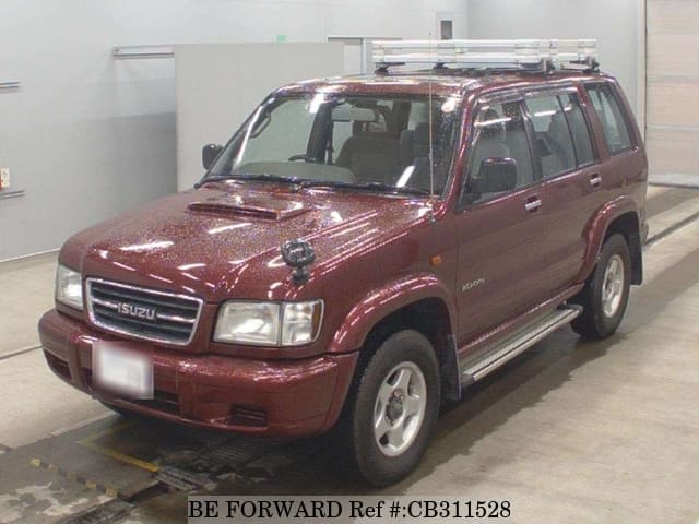 A grey JDM sports car speeding down a highway at night.
