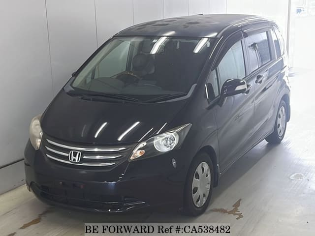 A grey JDM sports car speeding down a highway at night.