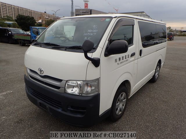 A grey JDM sports car speeding down a highway at night.