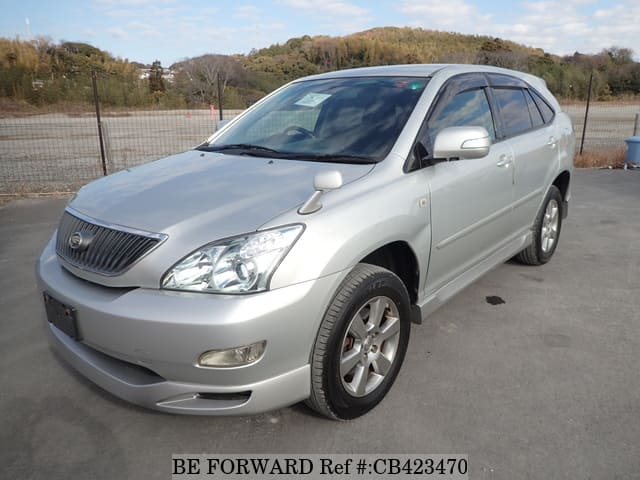 A grey JDM sports car speeding down a highway at night.