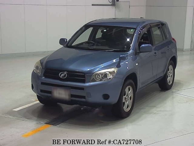 A grey JDM sports car speeding down a highway at night.