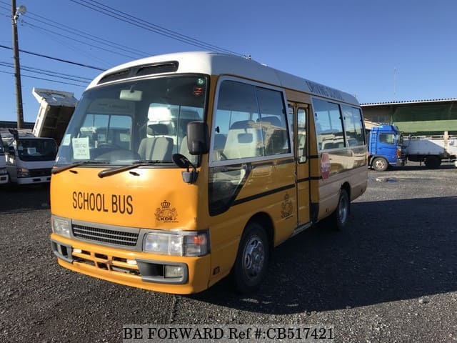 A grey JDM sports car speeding down a highway at night.