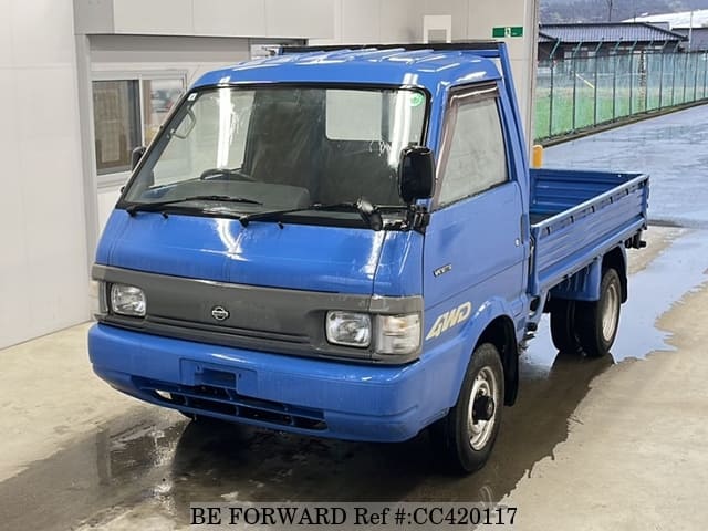 A grey JDM sports car speeding down a highway at night.