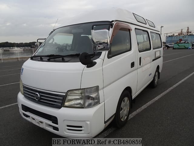 A grey JDM sports car speeding down a highway at night.